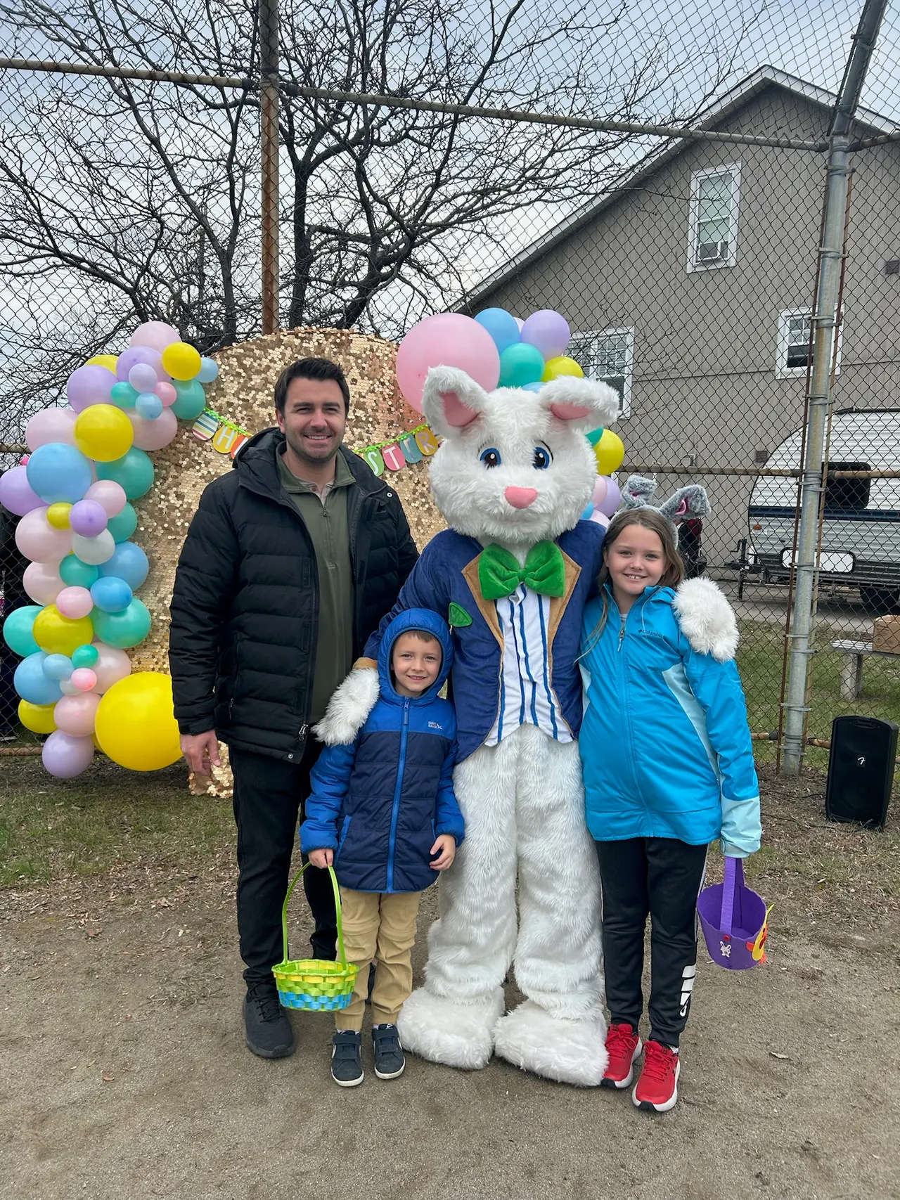 Matt Francis with children and the Easter Bunny at a community Easter event