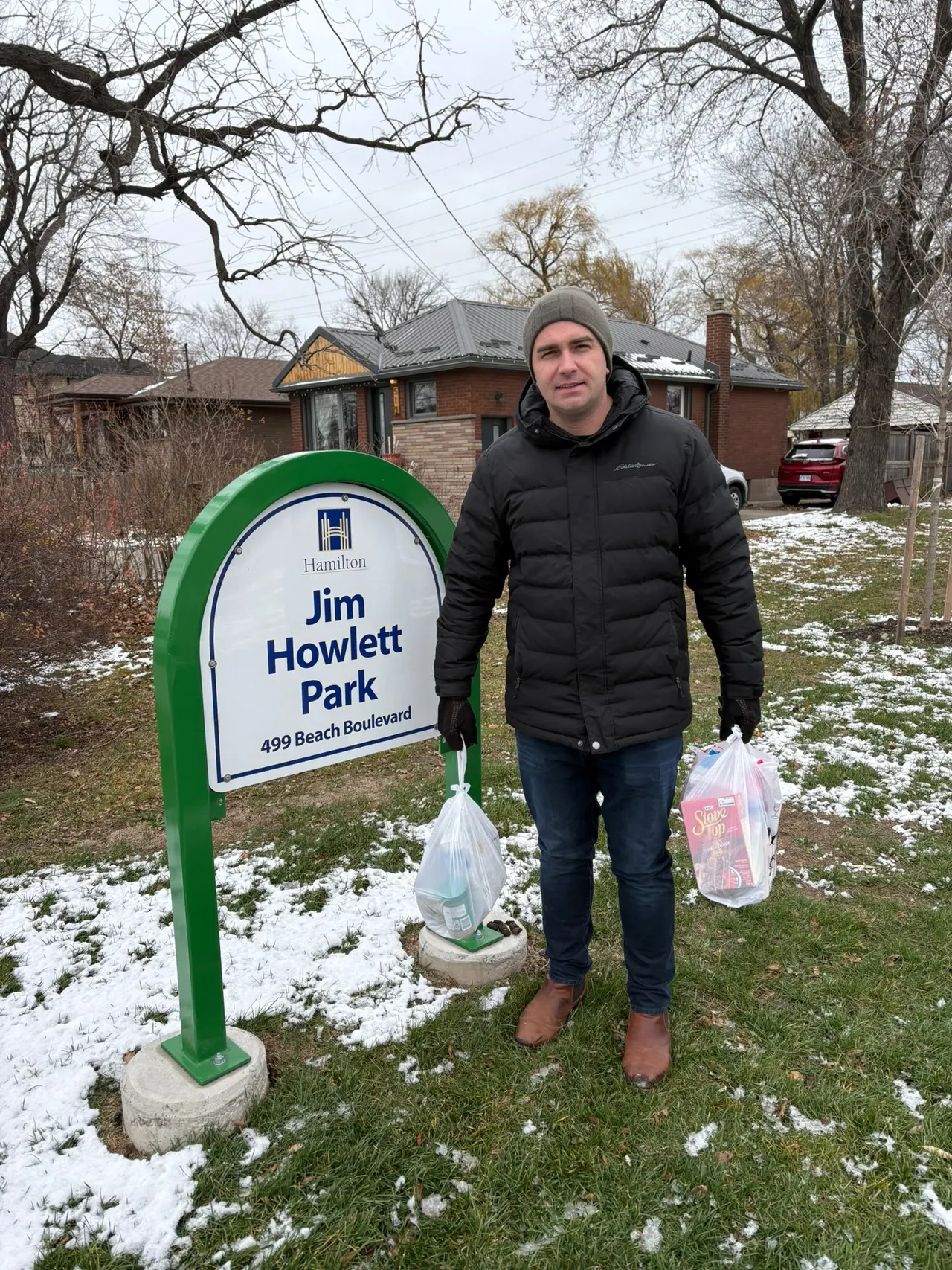 Matt Francis beside the Jim Howlett Park sign on Beach Boulevard