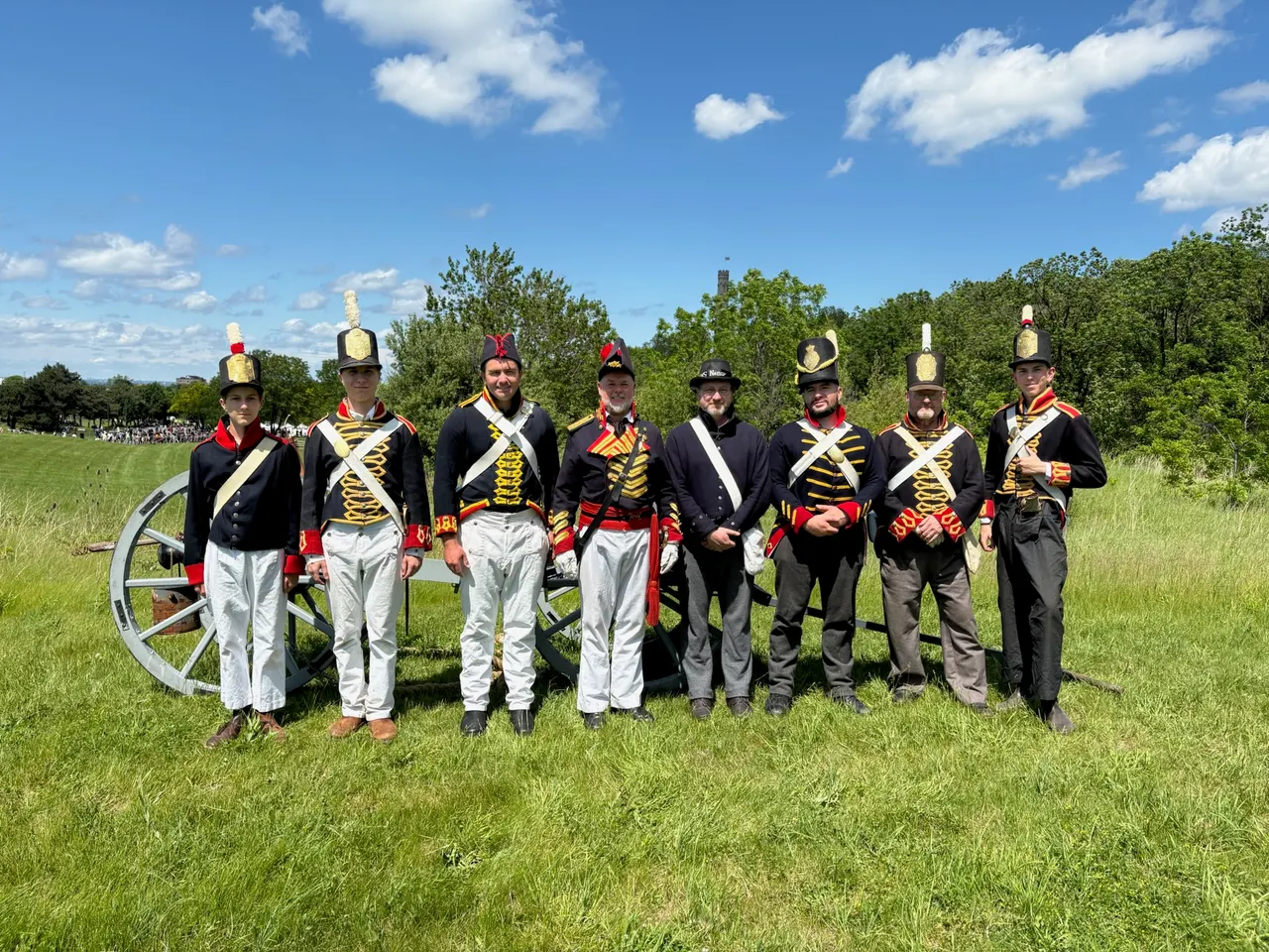 Battle of Stoney Creek re-enactors in period uniform beside a field cannon