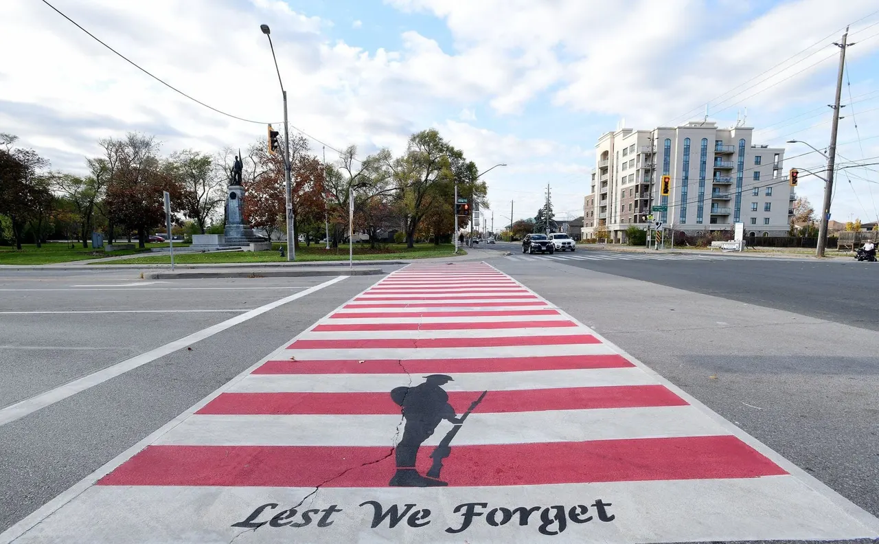 The Veterans' Crosswalk at the cenotaph, painted with a soldier's silhouette and the words Lest We Forget