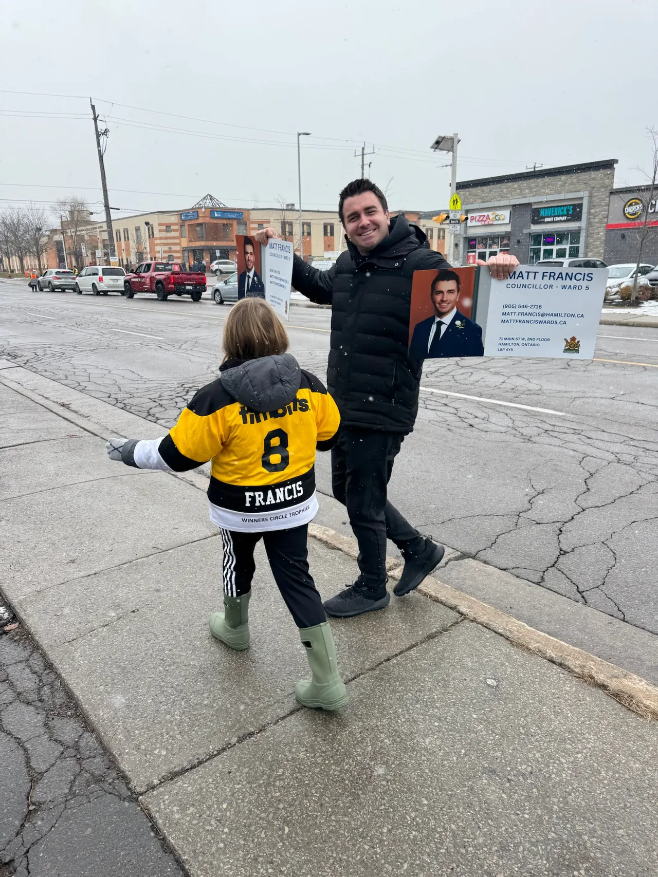 Matt Francis on a Ward 5 street with a young supporter in a Francis jersey